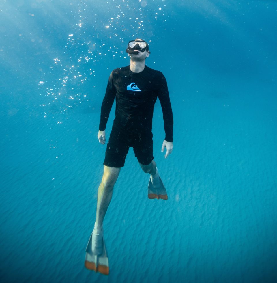 A tourist snorkels in the water on Rottnest Island