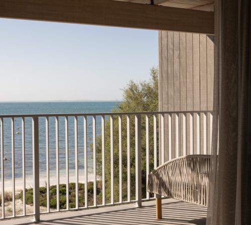 This room's terrace features two sunbeds and additional outdoor chairs