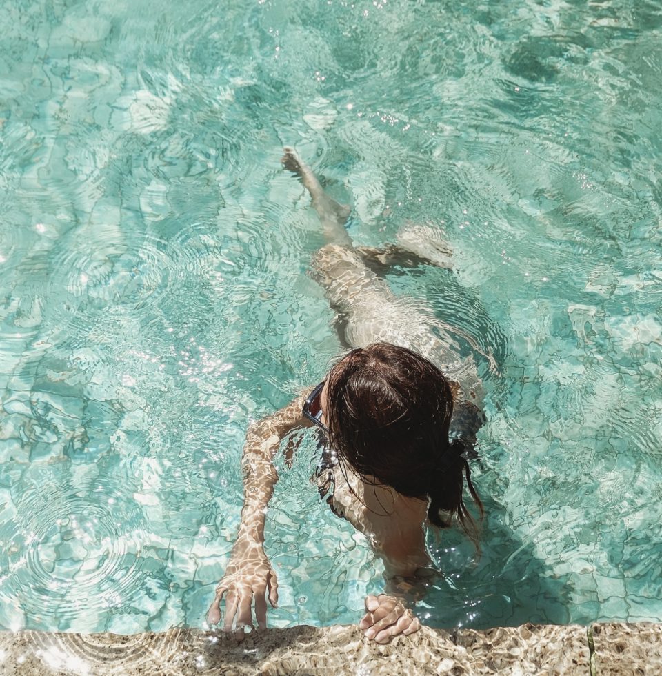 A guest holds onto the side wall of the pool at the Samphire Rottnest hotel