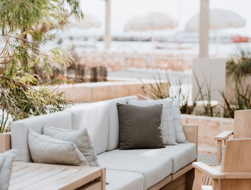 Couches and wooden chairs are arranged around Lontara Lounge