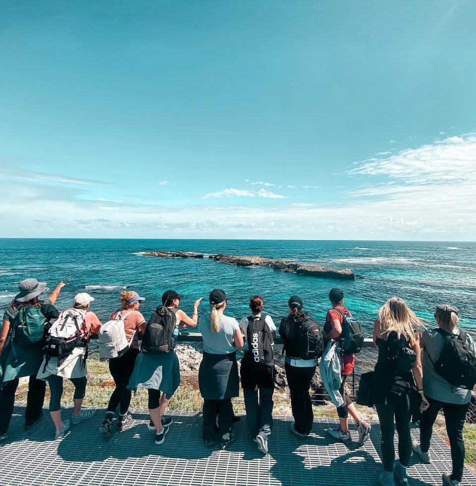 A group of hikers look out over the water at Rottnest Island