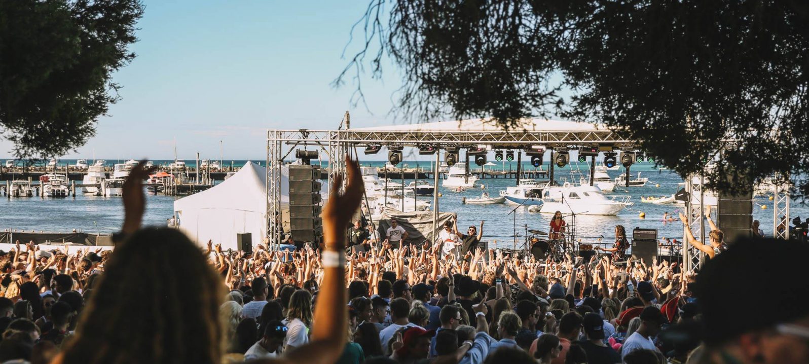 A crowd sings along and cheers at a musical festival on Rottnest Island