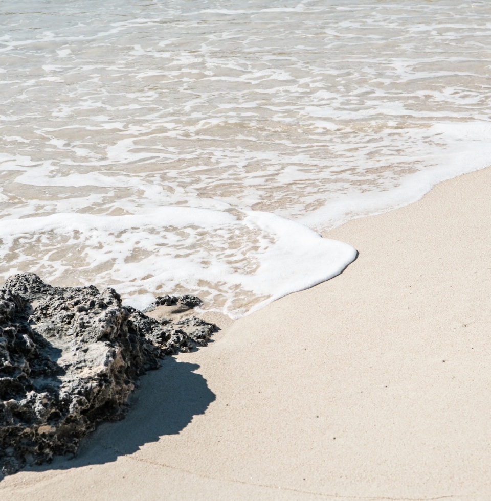 calm waters lapping at the soft white sand at Ricey Beach