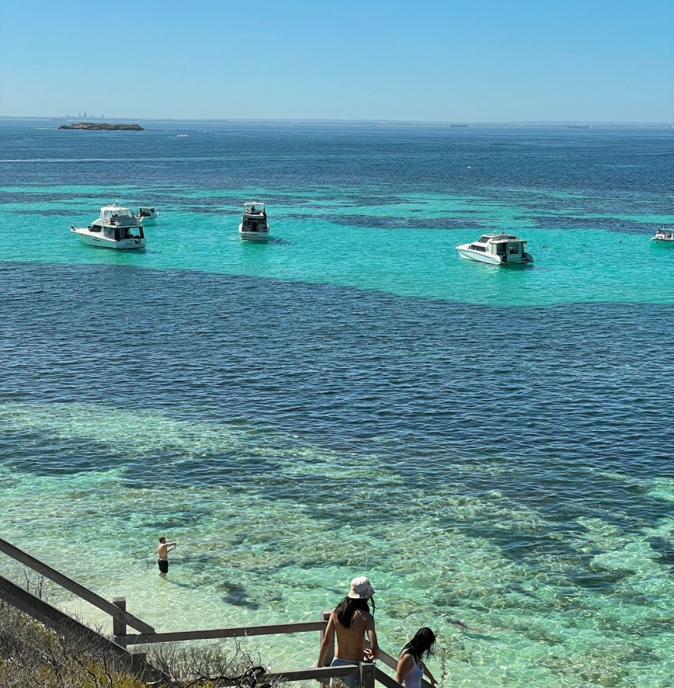 Stairs leading to the azure waters of Parker Point with yachts in the background